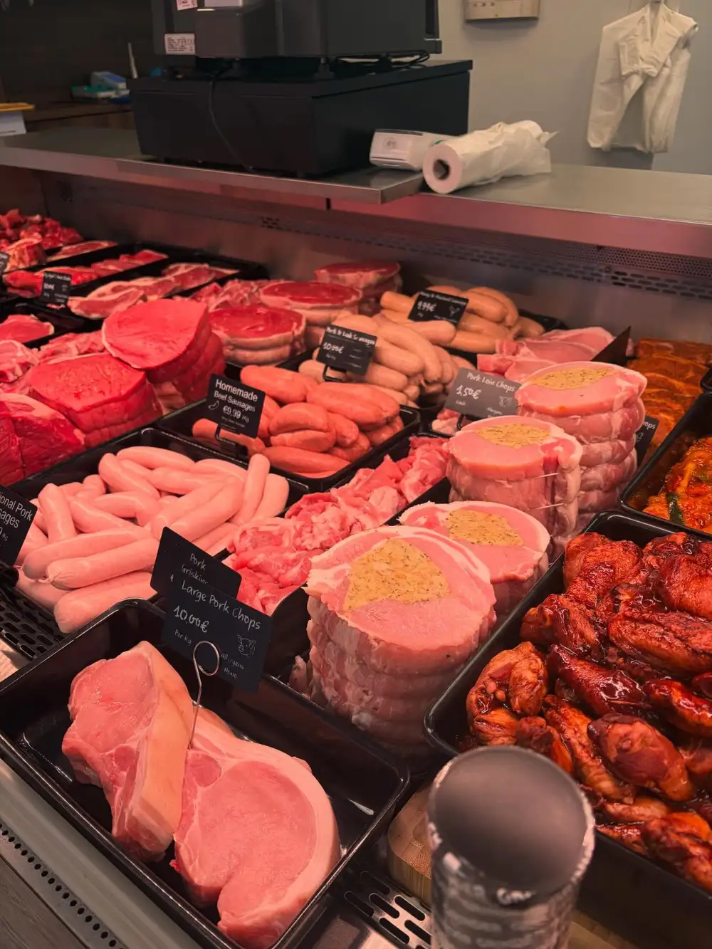 Homemade sausages, stuffed pork chops and marinated meats with handwritten price tickets