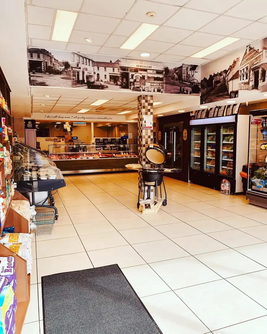 Inside McGurren's - the long counter, tiled floor, and heritage photographs of old Belturbet along the walls