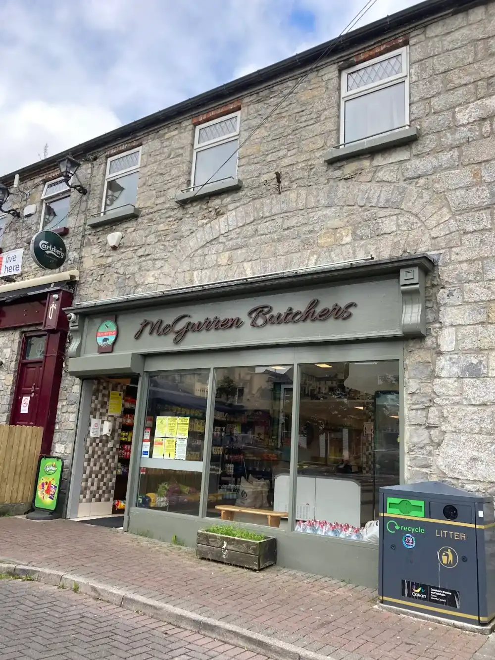 The McGurren Butchers shopfront on The Diamond - stone building with a sage-green fascia and script signage